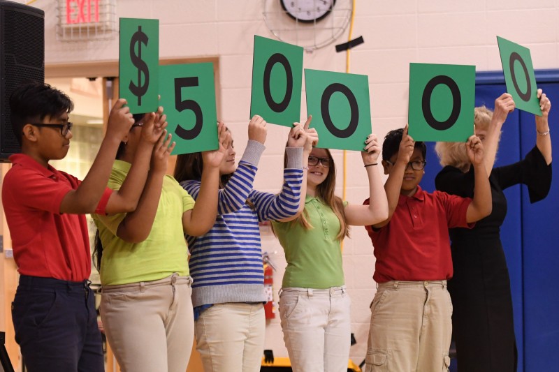 Perry Township Schools Students Hold Up Numbers Representing $50,000 Award